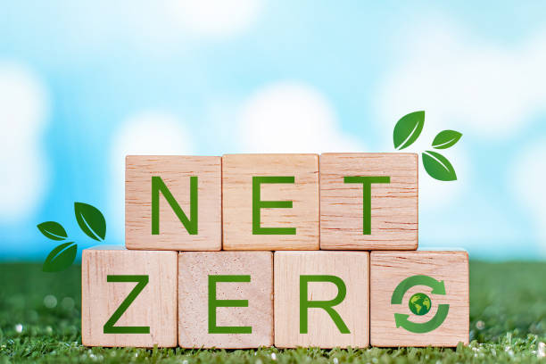 istock Net zero emissions concept. Carbon neutral. Climate neutral long term strategy. Sustainable business development. green business cube with net zero icon on the green grass. 1822334503