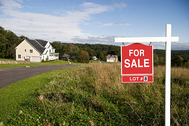 Sign informing of terrain with house for sale stock photo