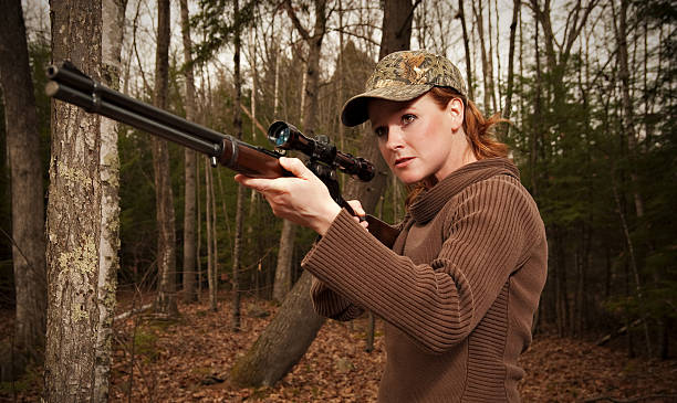 Mature woman aming a rifle on gray background. You might also be interested in these: 