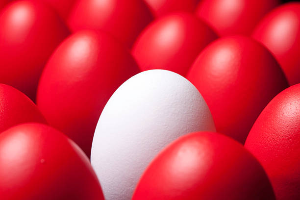 istock Individuality - one white egg among many red eggs 182234172