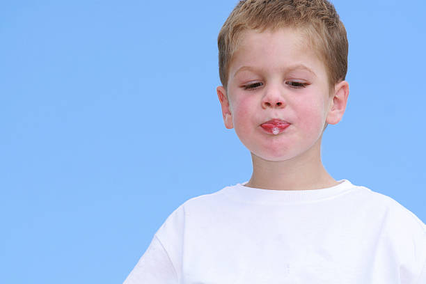 close up of a little boy плевать - human saliva стоковые фото и изображения