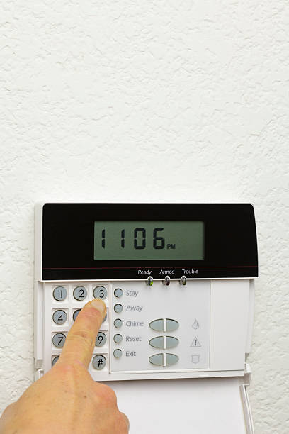 istock Woman arming a home alarm (vert) 182234241
