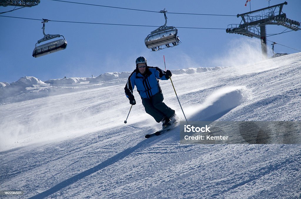 skiing "skier with helm on the slope, ski-lift in background" Helm - Nautical Vessel Part Stock Photo