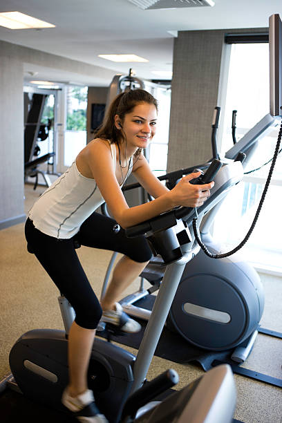 istock Woman on exercise bike 182234722