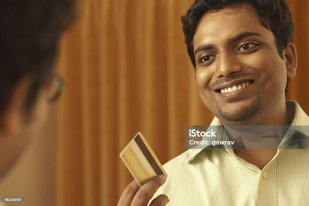 Heureux homme montrant sa carte de crédit à l'autre personne - Photo de Acheter libre de droits