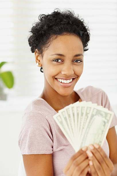 istock Happy young lady holding currency notes 182235221
