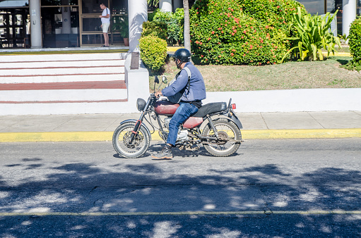 Man on old motorcycle in Varadero Cuba during winter day
