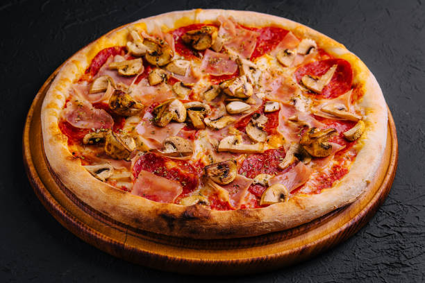 istock pizza with ham, salami and mushrooms 1822353542