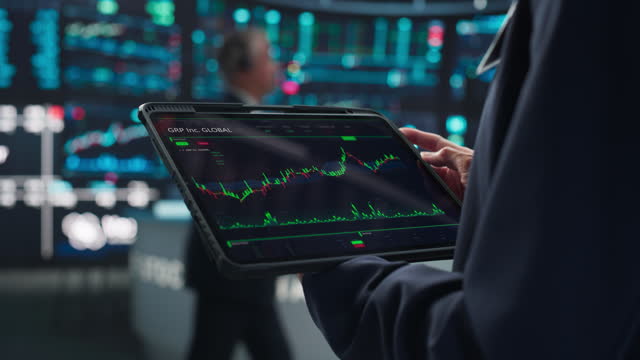 Anonymous Person Holding a Tablet Computer with Stock Market Analytics, Graphs and Reports on Screen. Stock Exchange Application Template. Banker Monitoring Financial and Business Opportunities