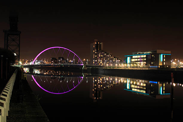 Modern Glasgow Skyline on Beautiful Still Night. (XL Image Size) "Office blocks, Apartments and the Clyde Arc reflected in the River Clyde at night." govan stock pictures, royalty-free photos & images