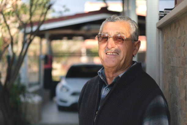 istock Handsome old man with eyeglasses looking at the camera and laughing. 1822368159