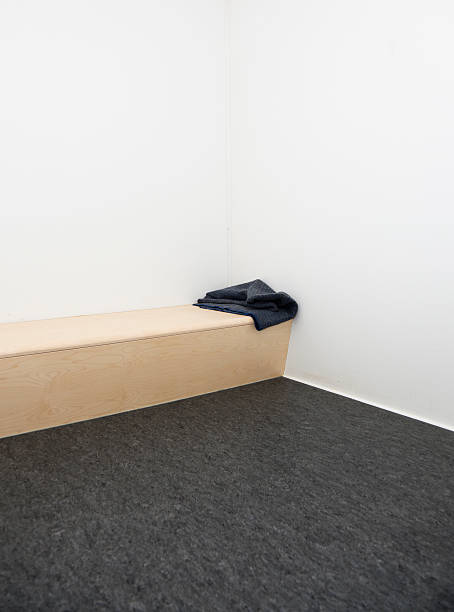 istock Modern holding cell in police station. Bench with a blanket. 182237060