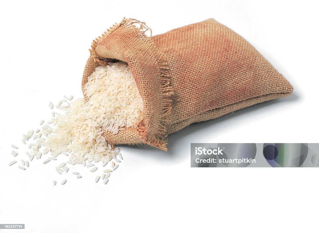 Hessian sack of rice. A hessian sack of white rice isolated on white. Rice - Food Staple Stock Photo