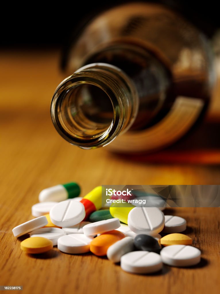 Tablets and Alcohol, Suicide "Colourful medical tables and alcohol, to portray  suicide.Click on the link below to see more of my medical images." Alcohol - Drink Stock Photo