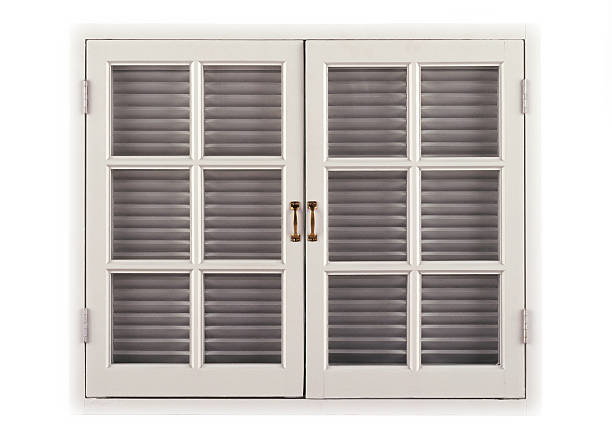 Window with closed off white shutters stock photo