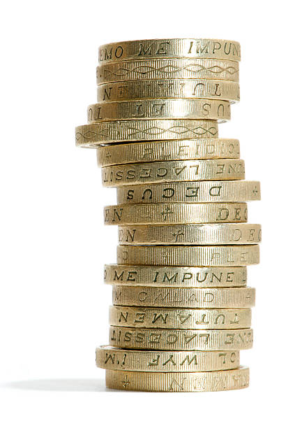 Stack of gold pound coins with writing on the sides "Stack of gold, one pound coins on white." one pound coin uk coin british currency stock pictures, royalty-free photos & images