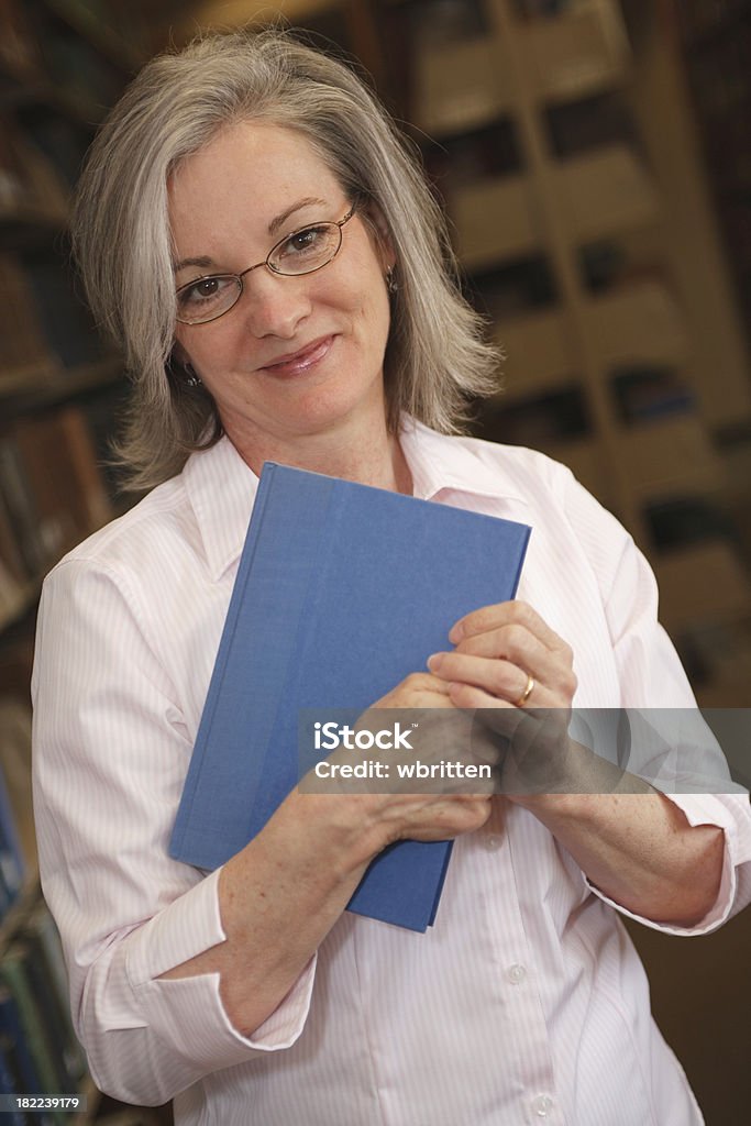 Woman in Library Series "Professor, librarian, or adult student researching in the library." 40-44 Years Stock Photo