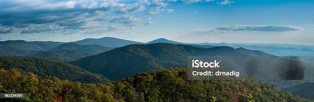 A stunning panorama of Blue Ridge Mountains A partially grey threatening sky casts darkness over the Blue Ridge Mountains and valleys, an indicator rain may soon fall. Photo taken on the Skyline Drive in Shenandoah National Park.  Blue Ridge Mountains Stock Photo