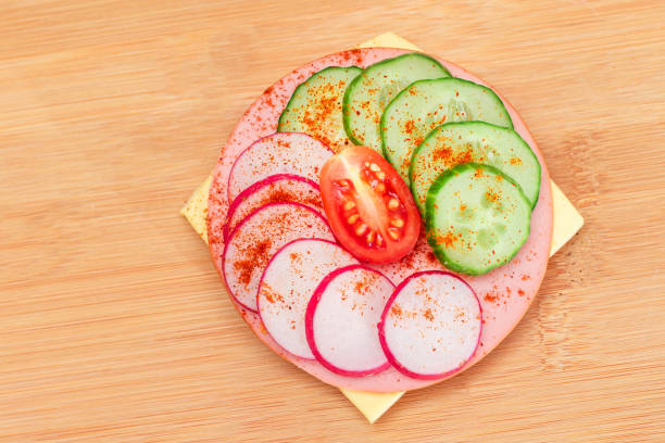 istock Cracker Sandwich with Fresh Cucumber, Cheese, Sausage, Radish and Tomato 1822392694