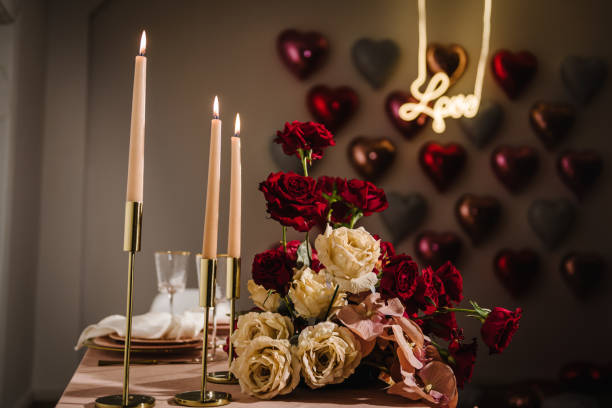 istock Romantic date. Luxury candlelight dinner table setup for couple on Valentine's day. Table setting in restaurant. Location decoration red flowers and decor with candles for surprise marriage proposal. 1822401313