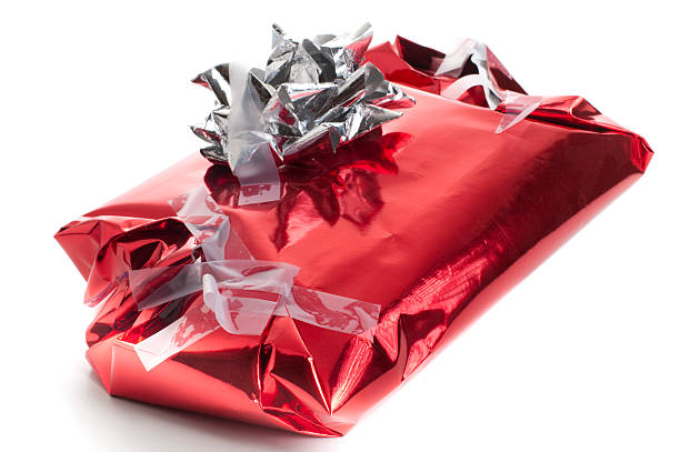 Badly wrapped, messy Christmas present "Poorly wrapped Christmas present, with tape everywhere and badly folded ends" wrapping paper stock pictures, royalty-free photos & images