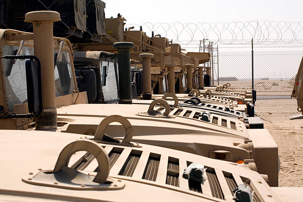 Army Trucks HUMVEE Row of Army HUMVEE's in a Desert Motor Pool military deployment photos stock pictures, royalty-free photos & images
