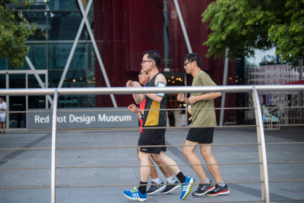 Singapore City, Singapore - September 08, 2019: The local population recreates by jogging in the Marina Bay pedestrian zone.