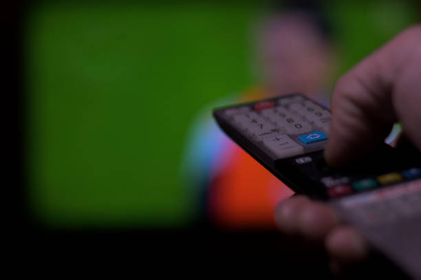 istock Hand with television remote control changing television channels horizontally soccer 1822418328