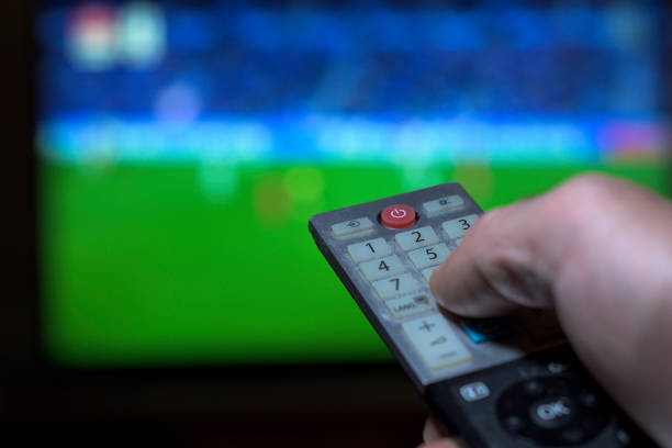istock Hand with television remote control changing television channels horizontally 1822418329