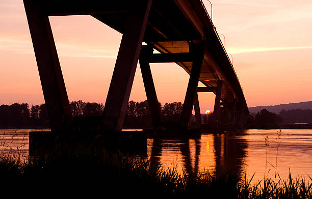 Bridge "Bridge over the Fraser River at Mission - Abbotsford, BC.  Sunset." abbotsford canada stock pictures, royalty-free photos & images