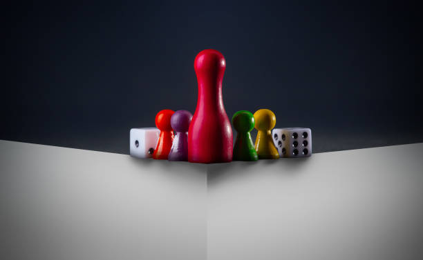 istock Board game concept -Time to play a game. Many different figures and dices. Dark background free space for text 1822420741