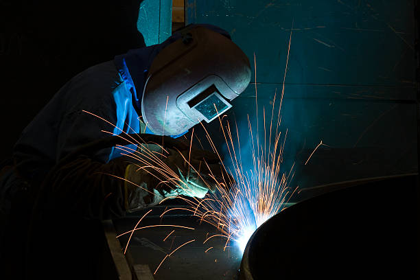 istock Welder wearing a mask and creating sparks 182242297