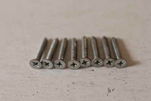 background and texture solid metal nails bolts. small consumables for repair and construction.