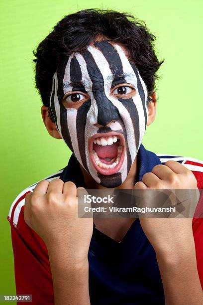 Cheering Team Screaming Indian Boy Zebra Strips Face Paint Stock Photo - Download Image Now