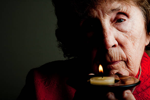 istock Elderly Woman Holding Candle 182242853