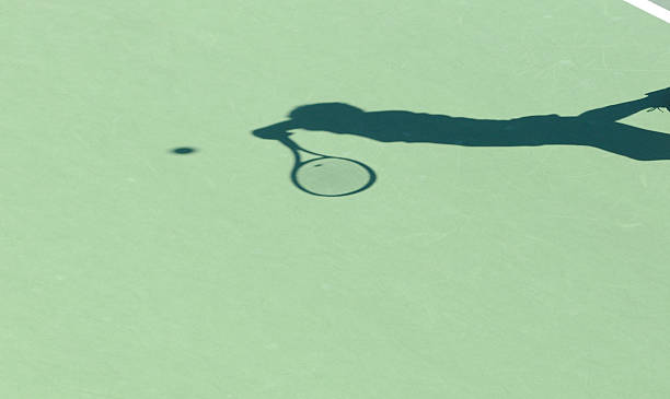 istock Shadow of tennis player serving 182242858