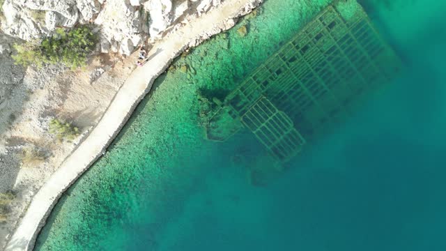 Ascending drone shot of an abandoned German Wehrmacht shipwreck in Zavratnica, Jablanac, Croatia