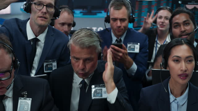 Portrait of Professional Traders Working on a Stock Exchange. Enthusiastic Men and Women Shouting, Signaling Orders for Company Shares and Commodities to Brokers at an Open Outcry Arbitrage