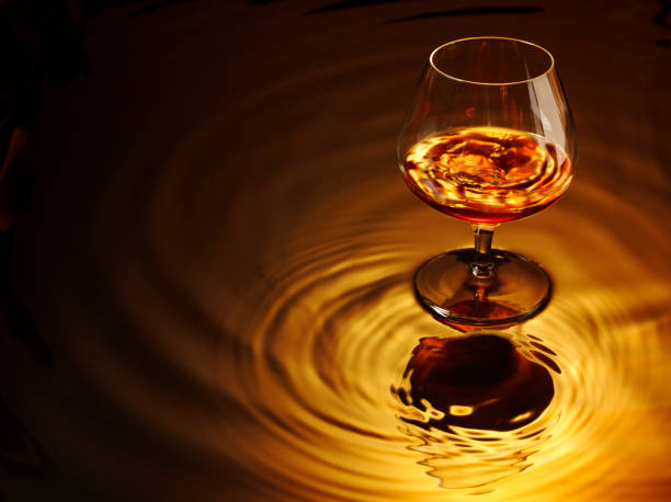 Brandy and Glass Glass of brandy sitting on water. Copy spaceClick on the link below to see more of my drink images. cognac brandy photos stock pictures, royalty-free photos & images