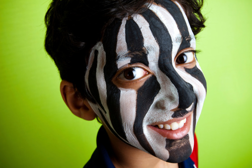 Indian Boy wearing a Zebra Strips on his face