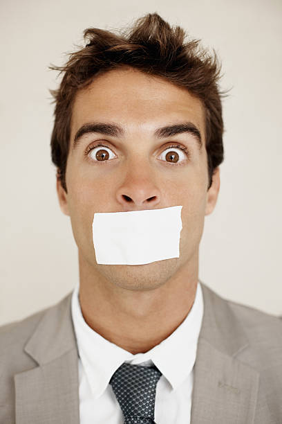 istock Young business man with a tape over mouth 182245061