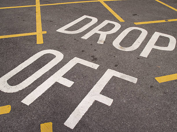istock Drop off point car park road markings. yellow hatching 182245263