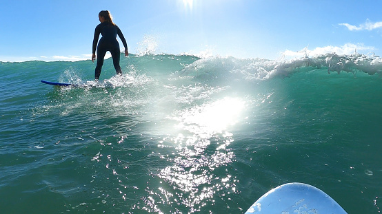 Young woman surfs perfect waves, Algarve