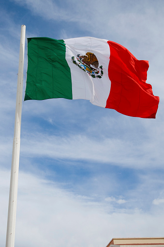 Gibraltar flag waving on the flagpole on a sky background