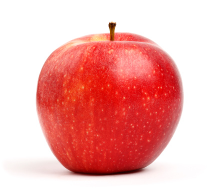 A red organic fuji apple isolated on a white background.