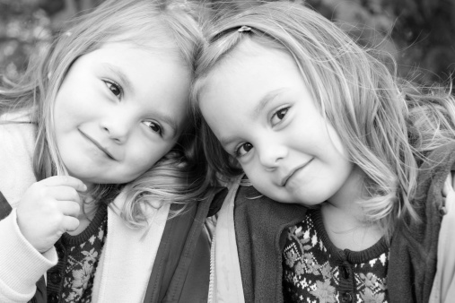 3 year old identical twin girls pose for a picture. Please view many other images of these beautiful girls in my portfolio.