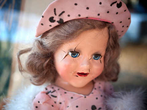 A broken doll from the forties at a garage sale.