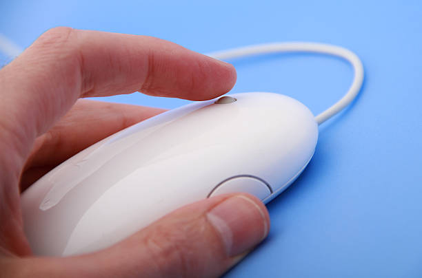 istock Close up of white computer mouse with human hand clicking 182247158