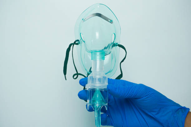 istock Holding Nebulizer mask isolated on white background. A nebulizer mask is a mask that is used in a nebulizer to convert liquid medicine into vapor so that it is easy for the patient to inhale 1822471810