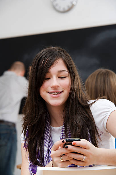 istock Teen Girl Texts While in Classroom 182248385